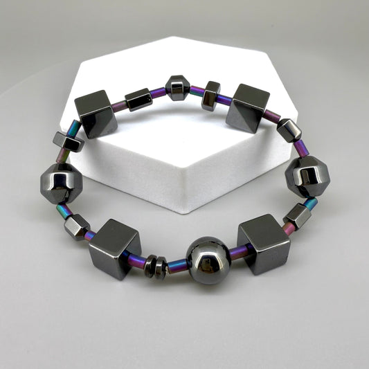 Hematite bracelet, 20cm, geometric cube and sphere beads with rainbow-toned connectors on elastic stretch band.