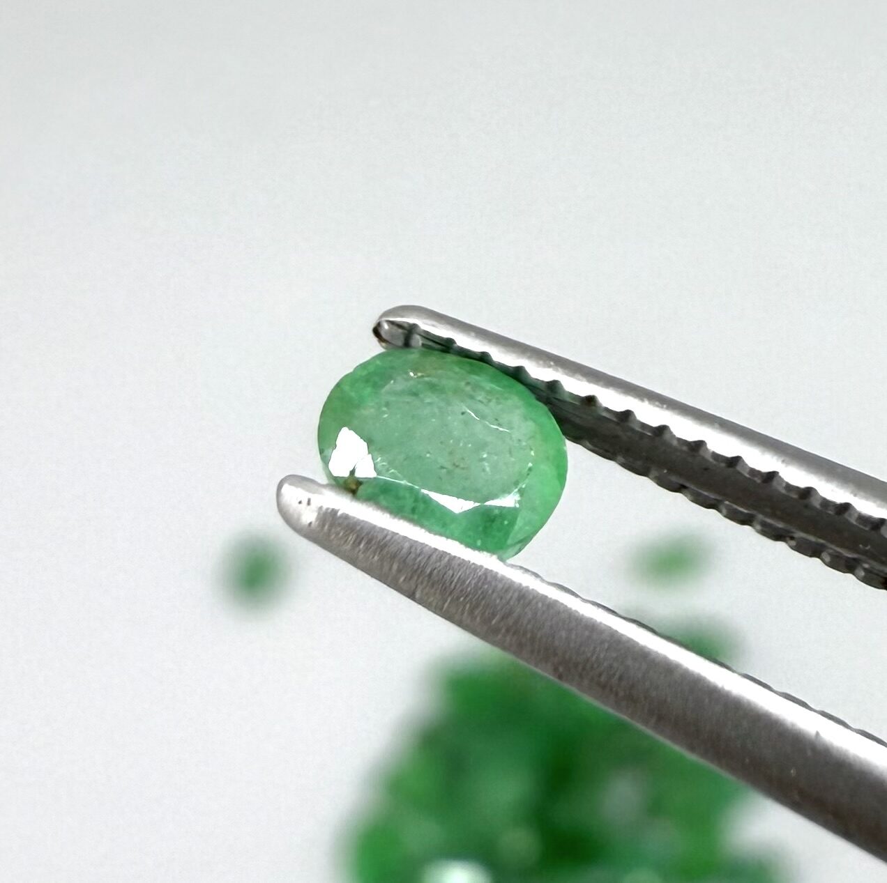 8.9 ct natural untreated Zambian emerald lot, faceted oval stones with vivid bluish-green color.