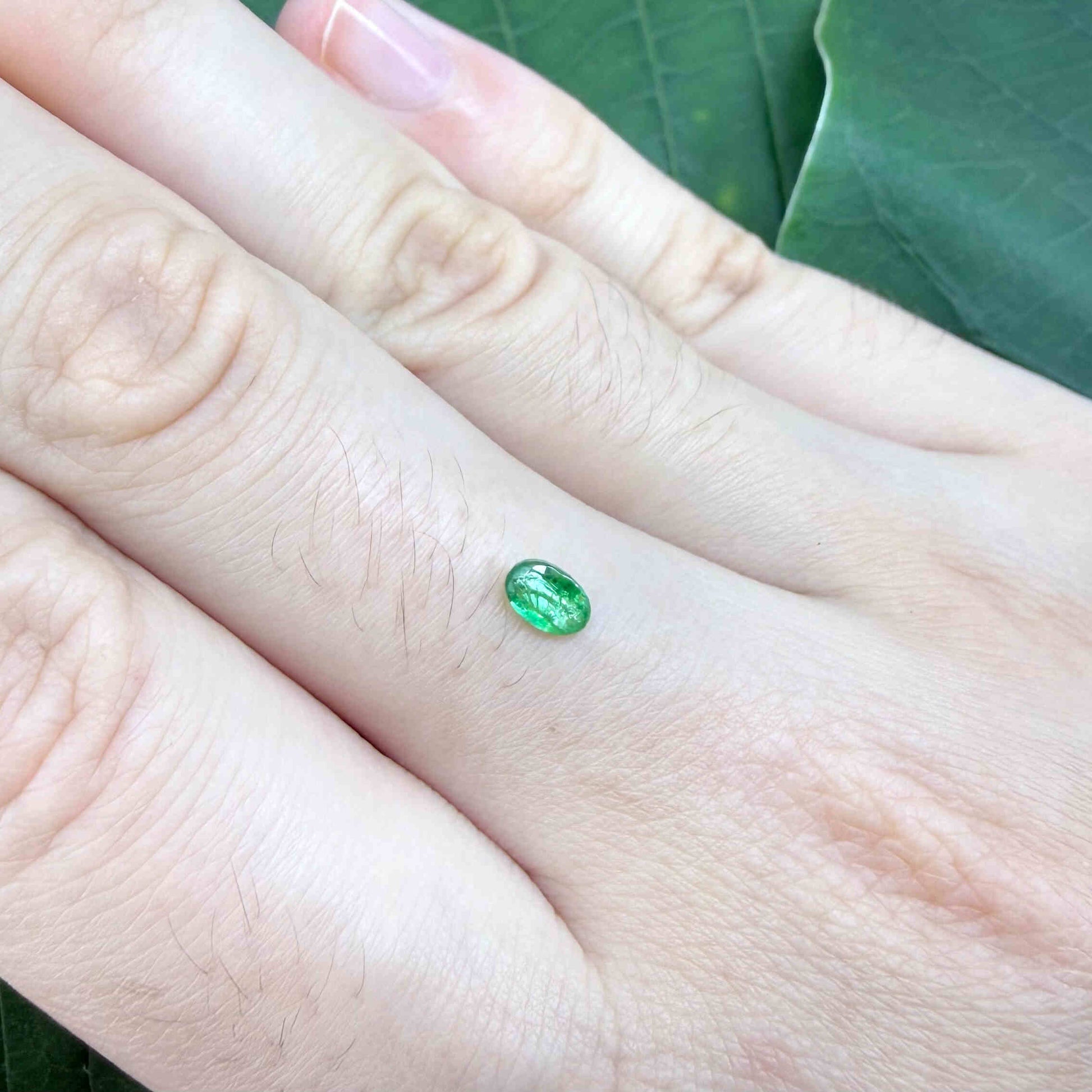 0.22 ct natural untreated Zambian emerald, oval faceted with bright bluish-green color.