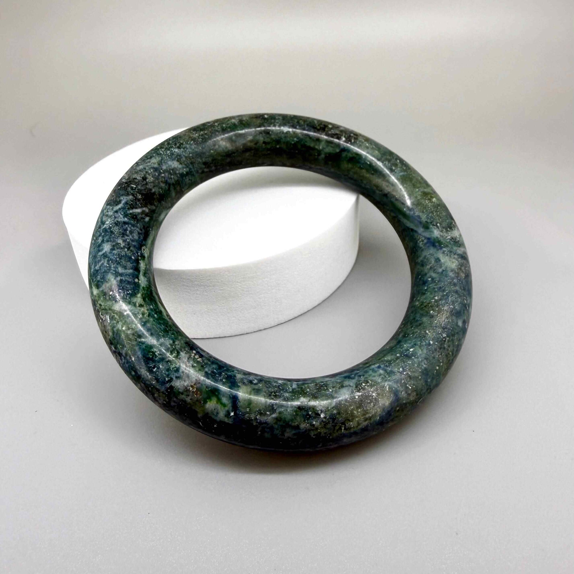 Polished green-blue jade bangle with smooth surface and natural color variations, 20 cm inner circumference