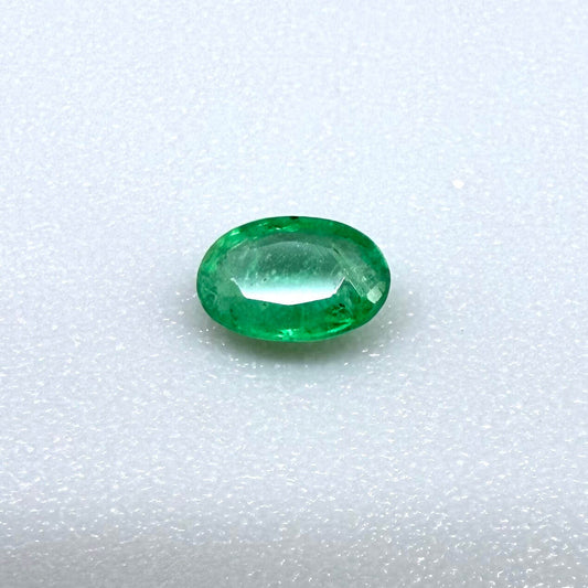 0.16 ct natural untreated Zambian emerald, oval faceted with vivid bluish-green color.
