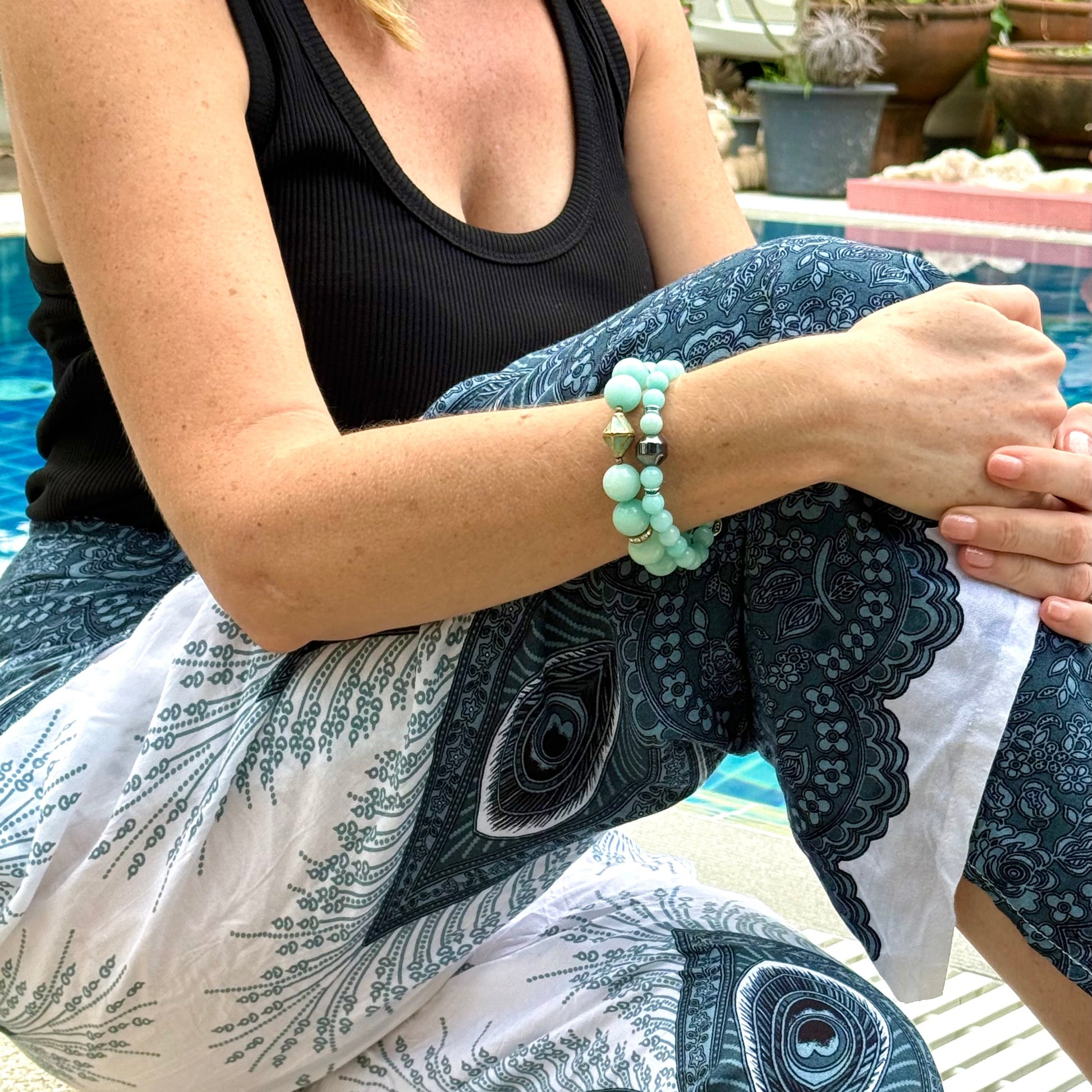 Larimar beaded bracelet, 18cm, aqua-blue gemstone beads with gold-toned spacers and decorative golden focal accent on elastic stretch band.