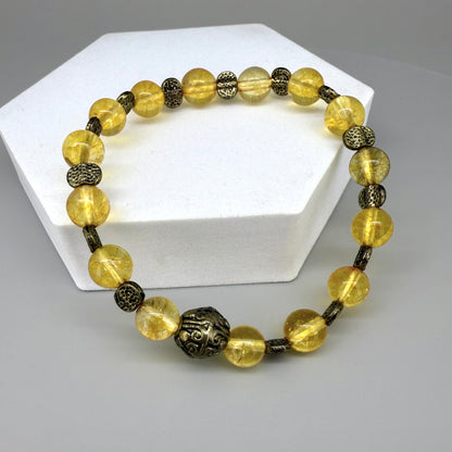 Citrine beaded bracelet, 18cm, golden-yellow gemstone beads with metal spacers on elastic stretch band.