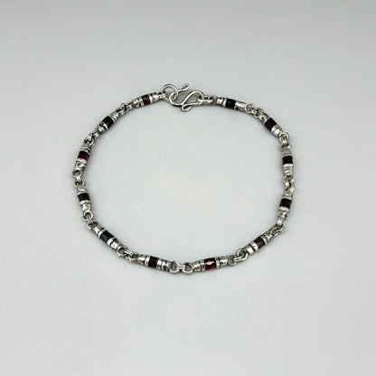 Garnet Pyrope bracelet in sterling silver with white gold plating, elegant design on neutral background