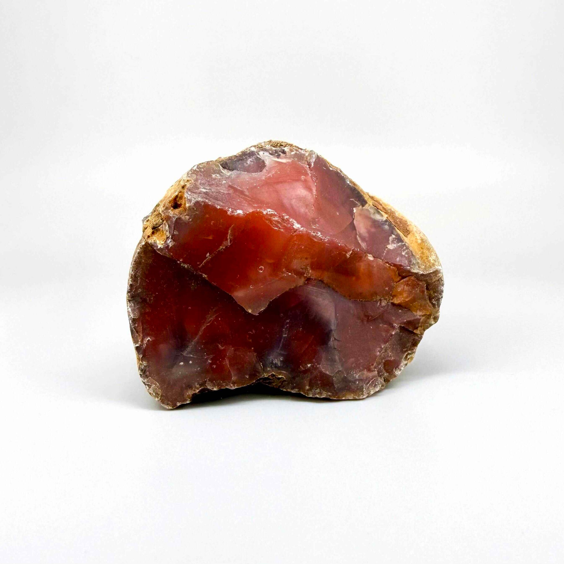 Natural red chalcedony rough (quartz) with warm orange to deep red tones, uncut gemstone.