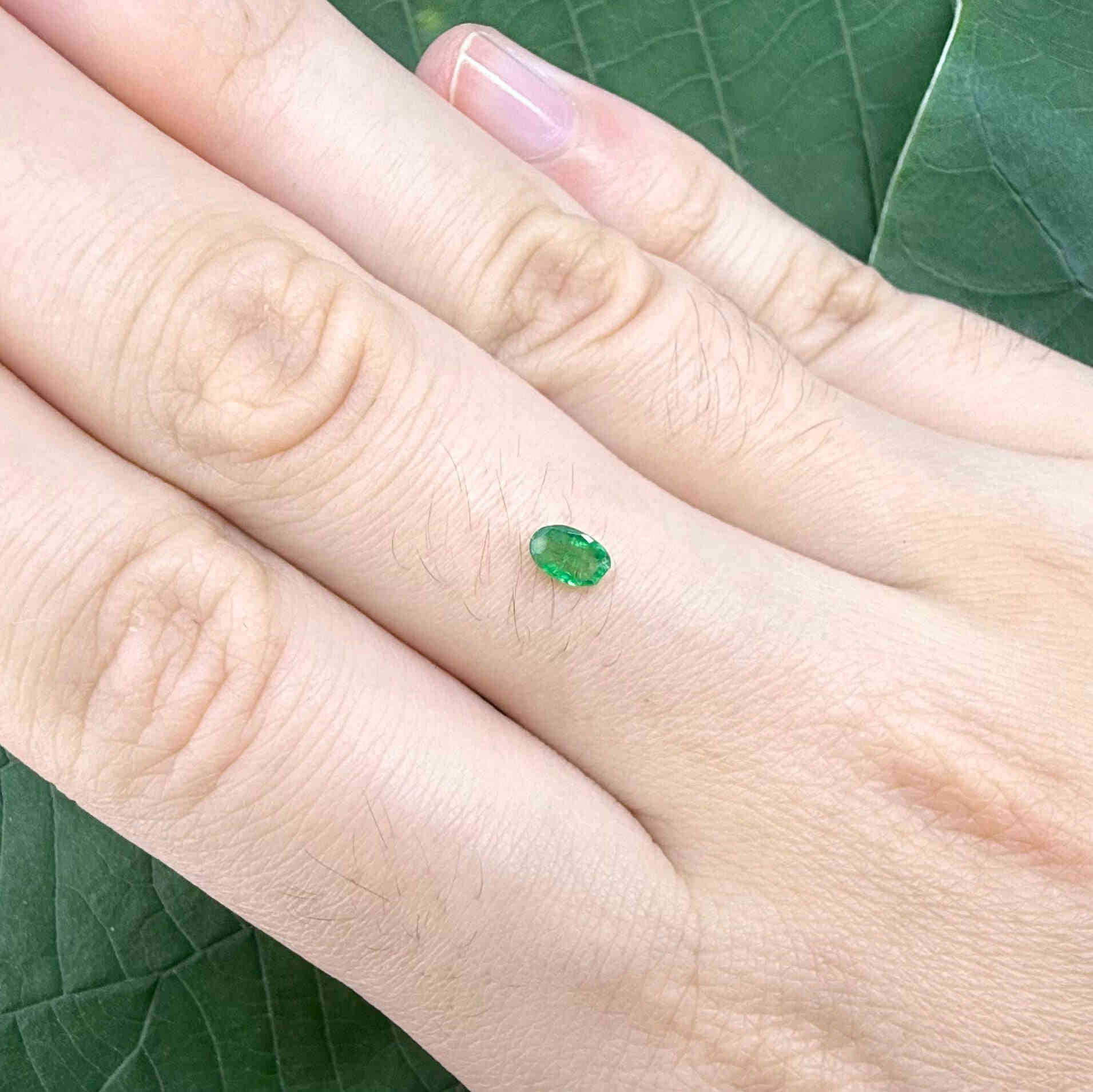 0.16 ct natural untreated Zambian emerald, oval faceted with bright bluish-green color.