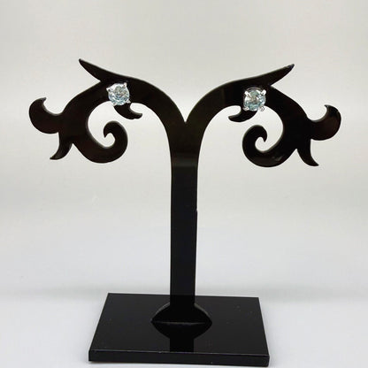 White gold plated sterling silver stud earrings featuring natural blue zircons with high brilliance and clarity.