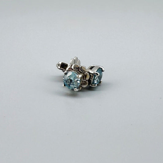 White gold plated sterling silver stud earrings featuring natural blue zircons with high brilliance and clarity.