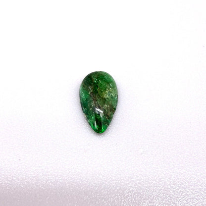 0.9 ct natural untreated emerald from Zambia, one side polished and the other cabochon-shaped.
