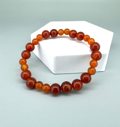 Carnelian beaded bracelet, 18cm, natural orange-red gemstone beads on elastic stretch band.
