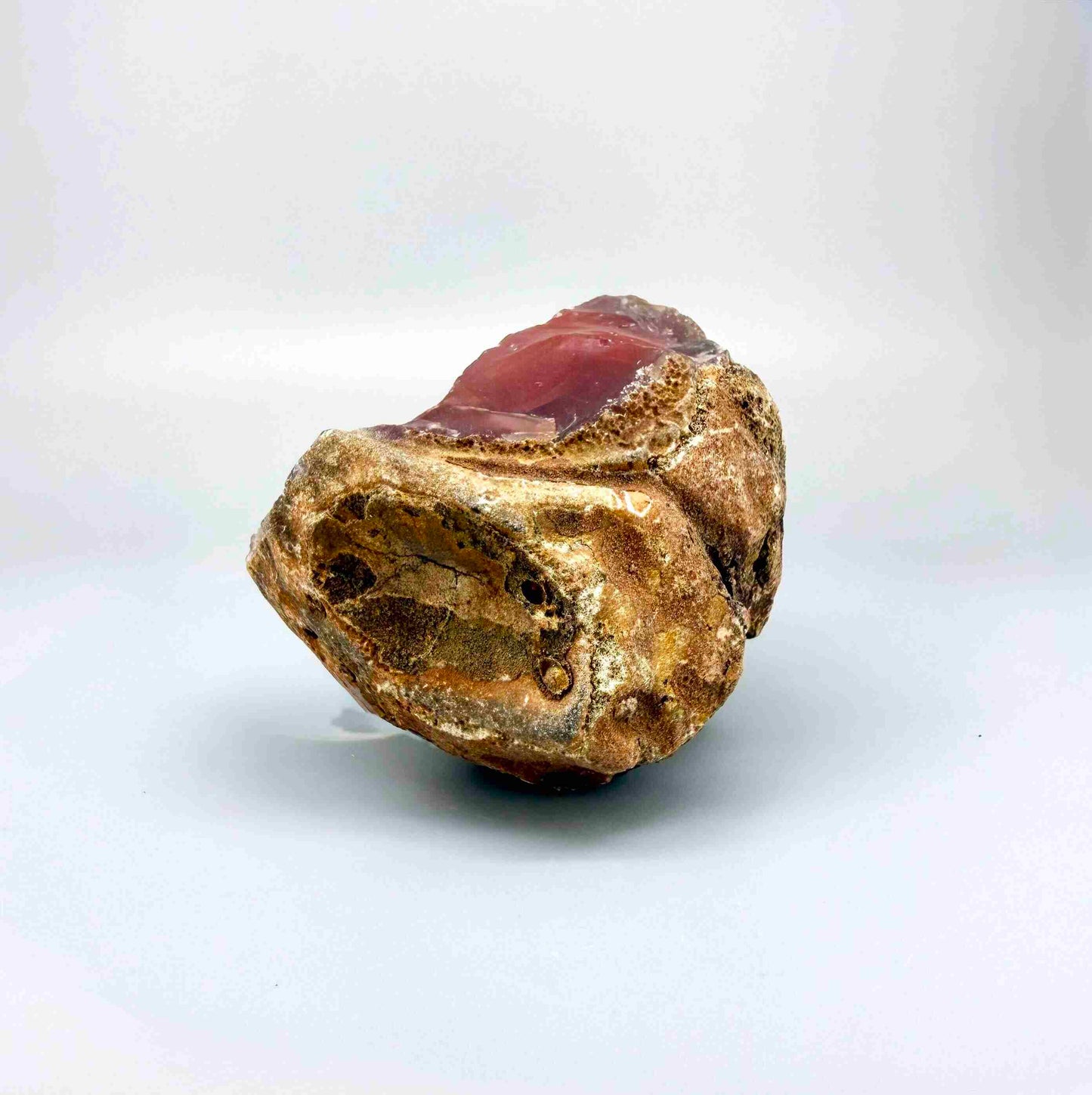 Natural red chalcedony rough (quartz) with warm orange to deep red tones, uncut gemstone.