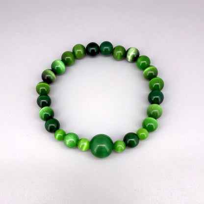 Green cat’s eye beaded bracelet, 18cm, shimmering green gemstone beads with one larger focal bead on elastic stretch band.