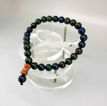 Sapphire mala bracelet made from natural sapphire beads, photographed on neutral background.