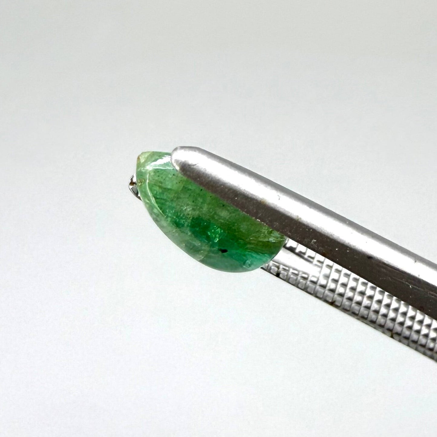 1.42 ct natural untreated emerald from Zambia, one side polished and the other cabochon-shaped.