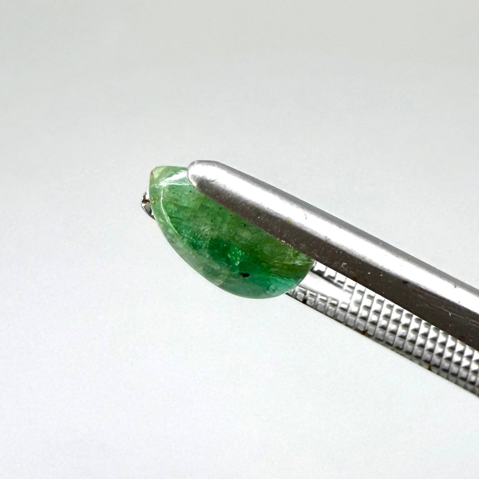 1.42 ct natural untreated emerald from Zambia, one side polished and the other cabochon-shaped.