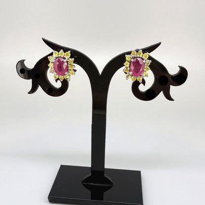 Ruby and yellow sapphire stud earrings in white gold plated sterling silver with butterfly backs.