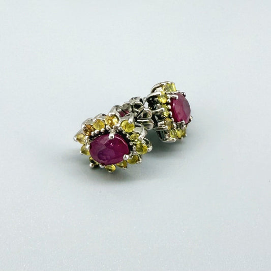 Ruby and yellow sapphire stud earrings in white gold plated sterling silver with butterfly backs.