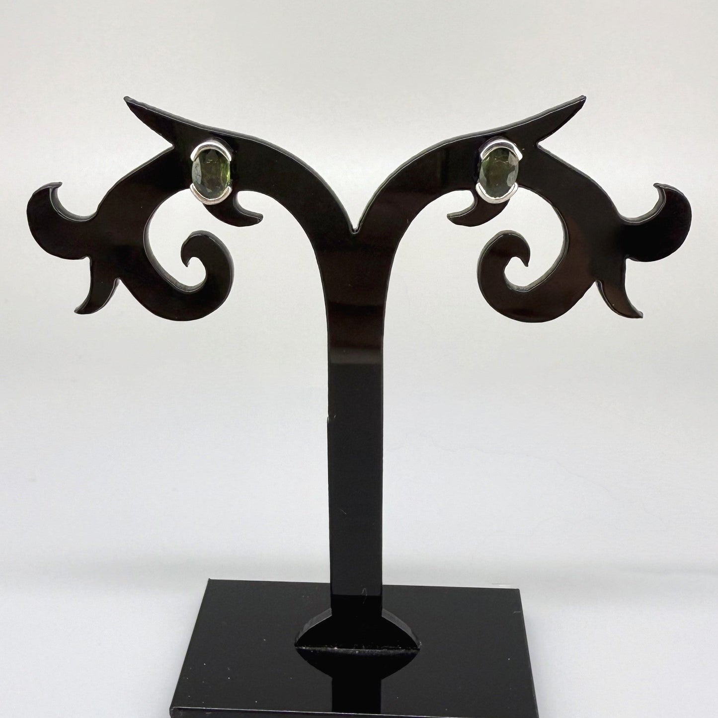 Green sapphire stud earrings in white gold plated sterling silver with butterfly backs.