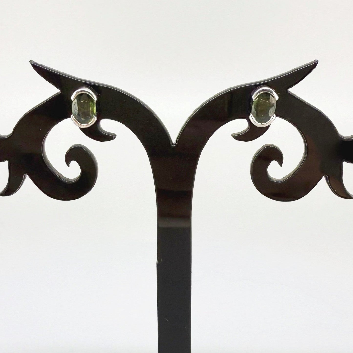 Green sapphire stud earrings in white gold plated sterling silver with butterfly backs.