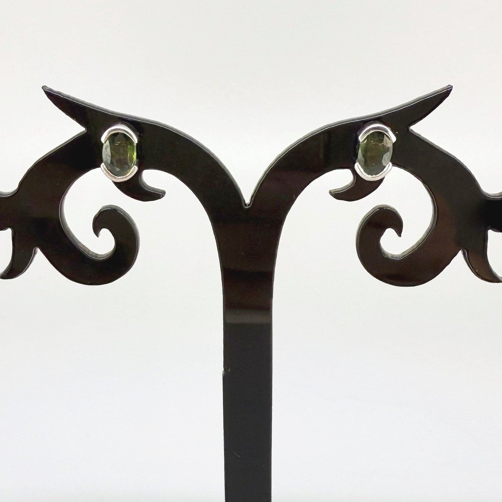 Green sapphire stud earrings in white gold plated sterling silver with butterfly backs.