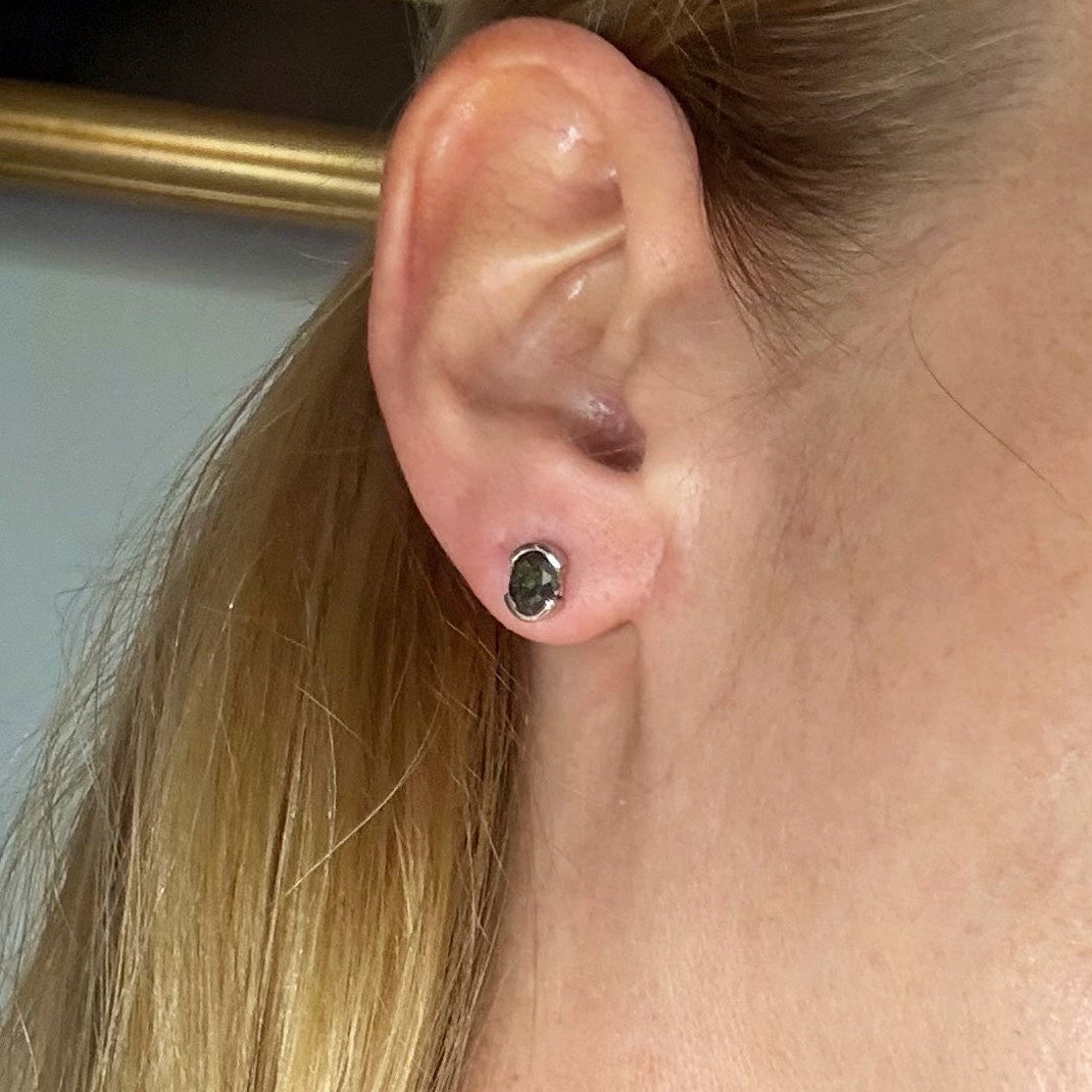 Green sapphire stud earrings in white gold plated sterling silver with butterfly backs.