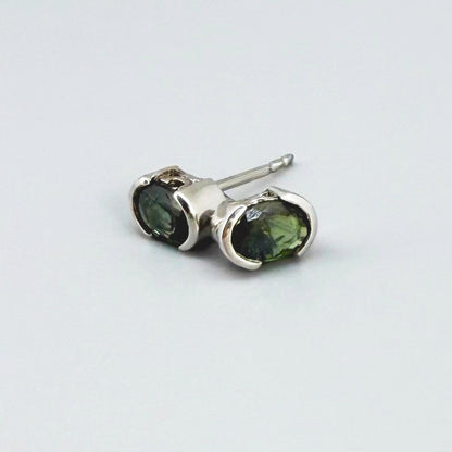Green sapphire stud earrings in white gold plated sterling silver with butterfly backs.
