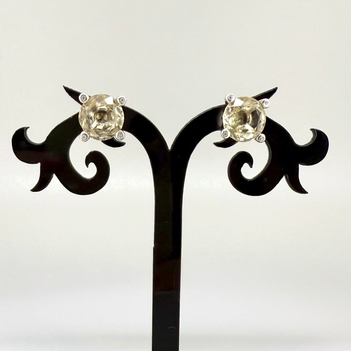 White gold plated silver stud earrings with 8.3 ct natural Lemon Quartz; golden-yellow gemstones in refined design.