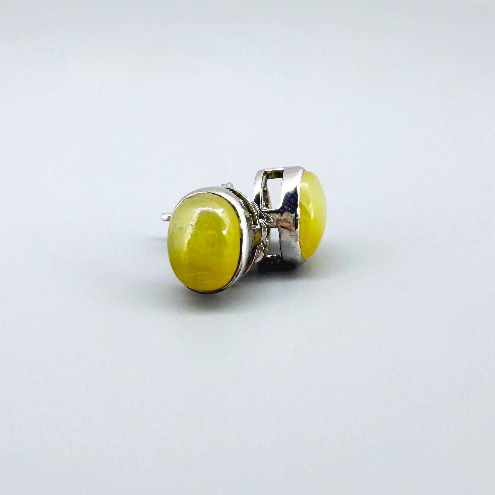 Yellow sapphire cabochon stud earrings in white gold plated sterling silver with butterfly backs.