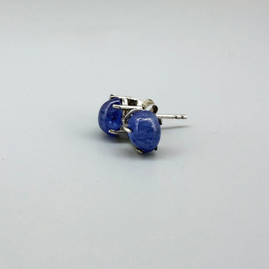 Sterling silver stud earrings with deep blue natural sapphires, plated in white gold for refined brilliance.