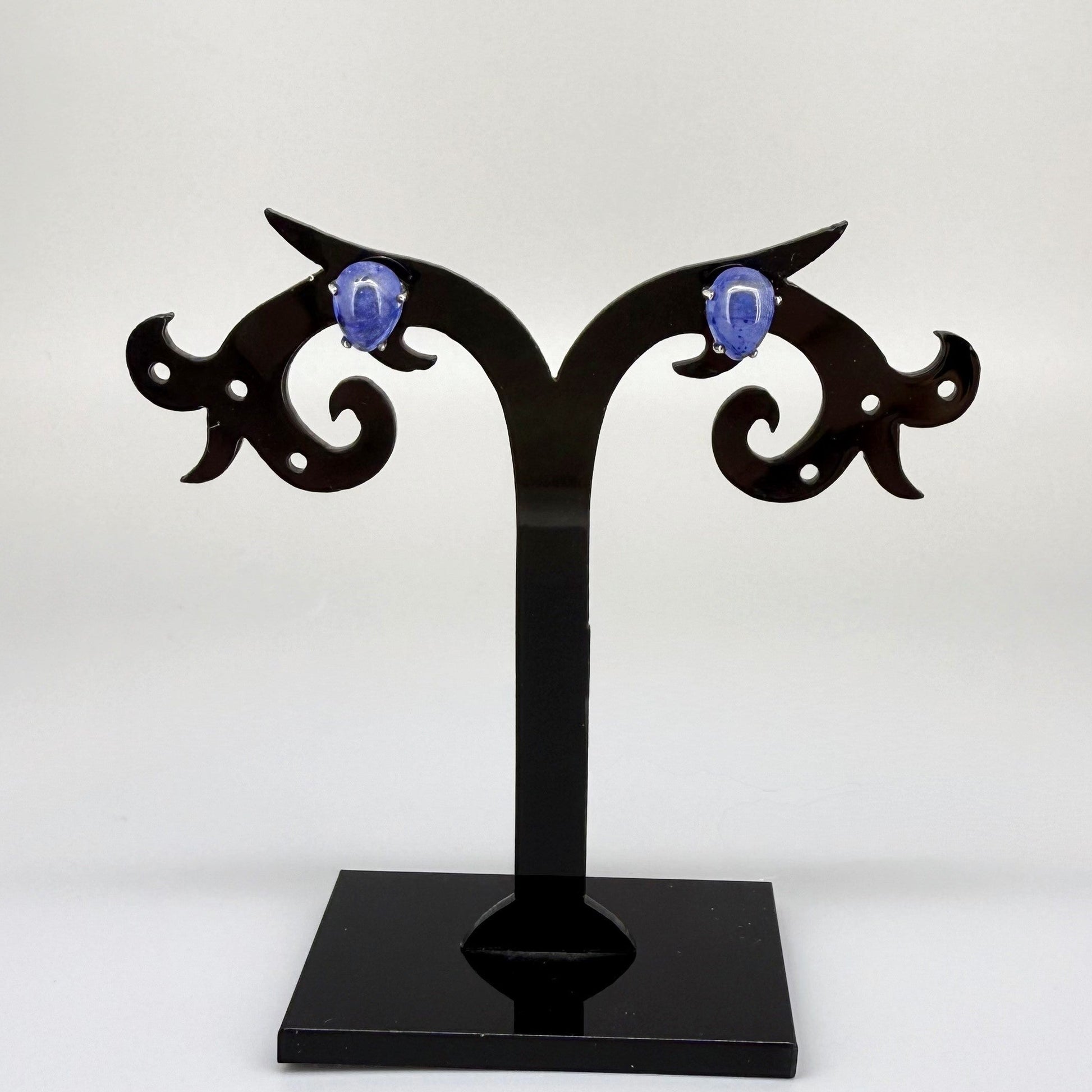 Sterling silver stud earrings with deep blue natural sapphires, plated in white gold for refined brilliance.