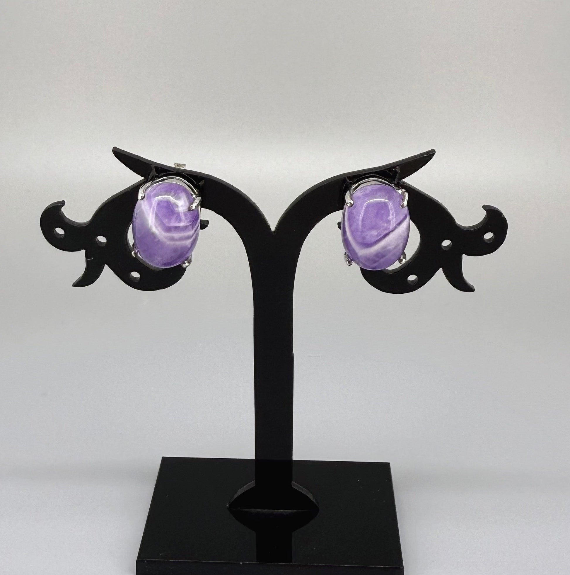 Natural amethyst stud earrings in white gold plated sterling silver with butterfly backs.