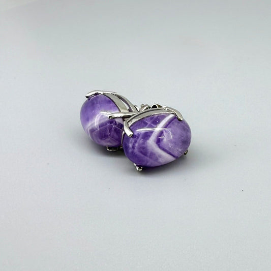 Natural amethyst stud earrings in white gold plated sterling silver with butterfly backs.