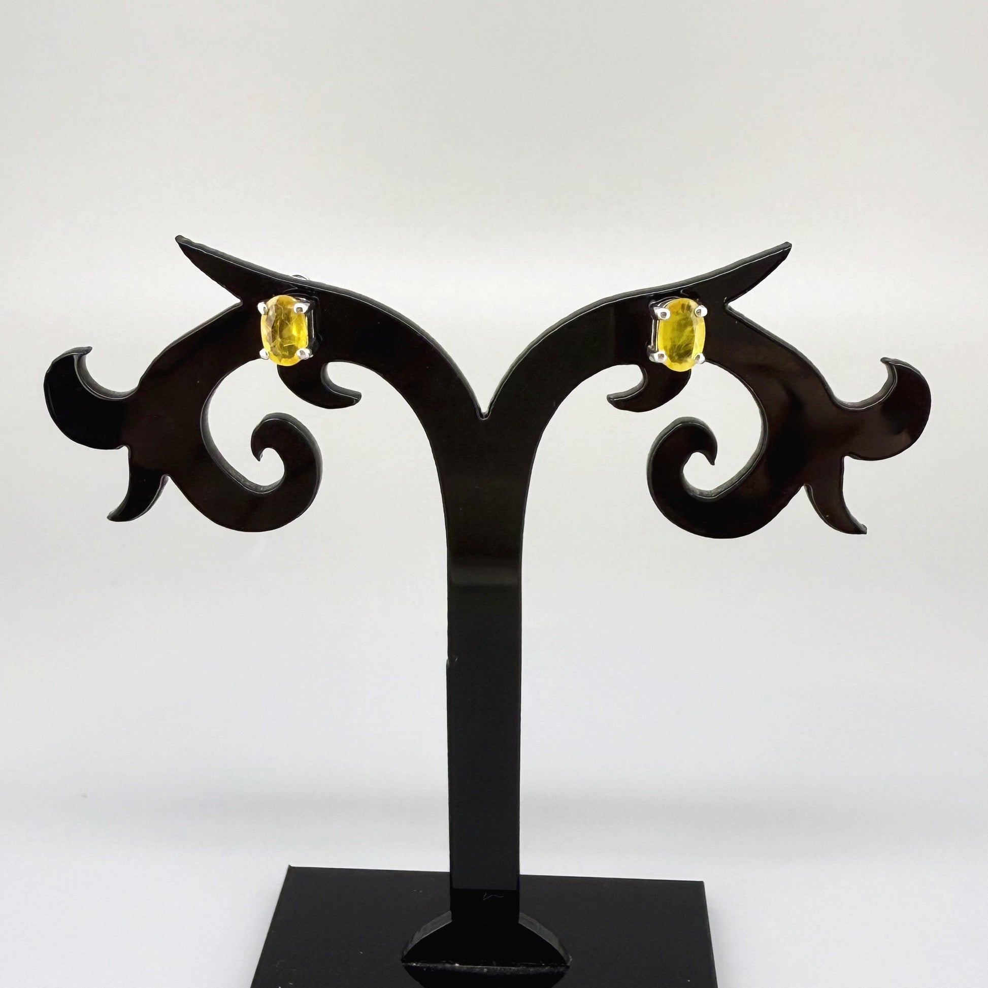Natural yellow sapphire stud earrings in white gold plated sterling silver with butterfly backs.