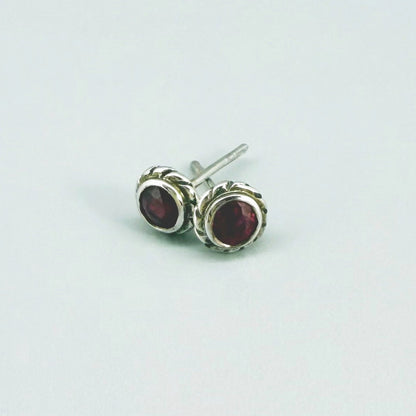 Ruby stud earrings in white gold plated sterling silver with butterfly backs.