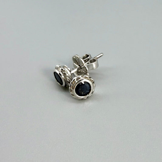Blue sapphire stud earrings in white gold plated sterling silver with round floral backs.