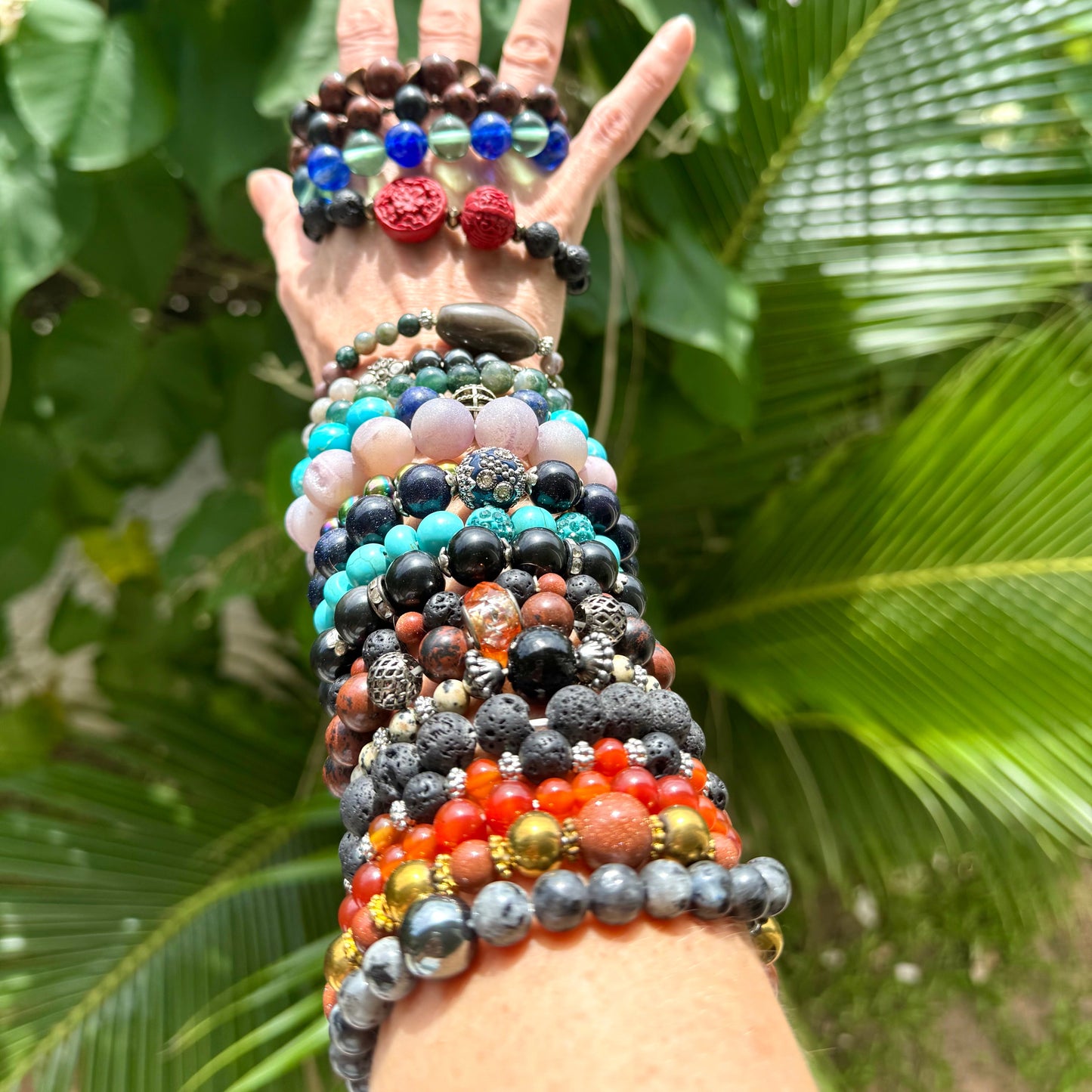 Multi natural beaded gemstone bracelets worn on arm 