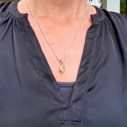 Handmade white gold plated silver pendant with 14.76 ct rose quartz and cubic zirconia accents, elegant and refined design.