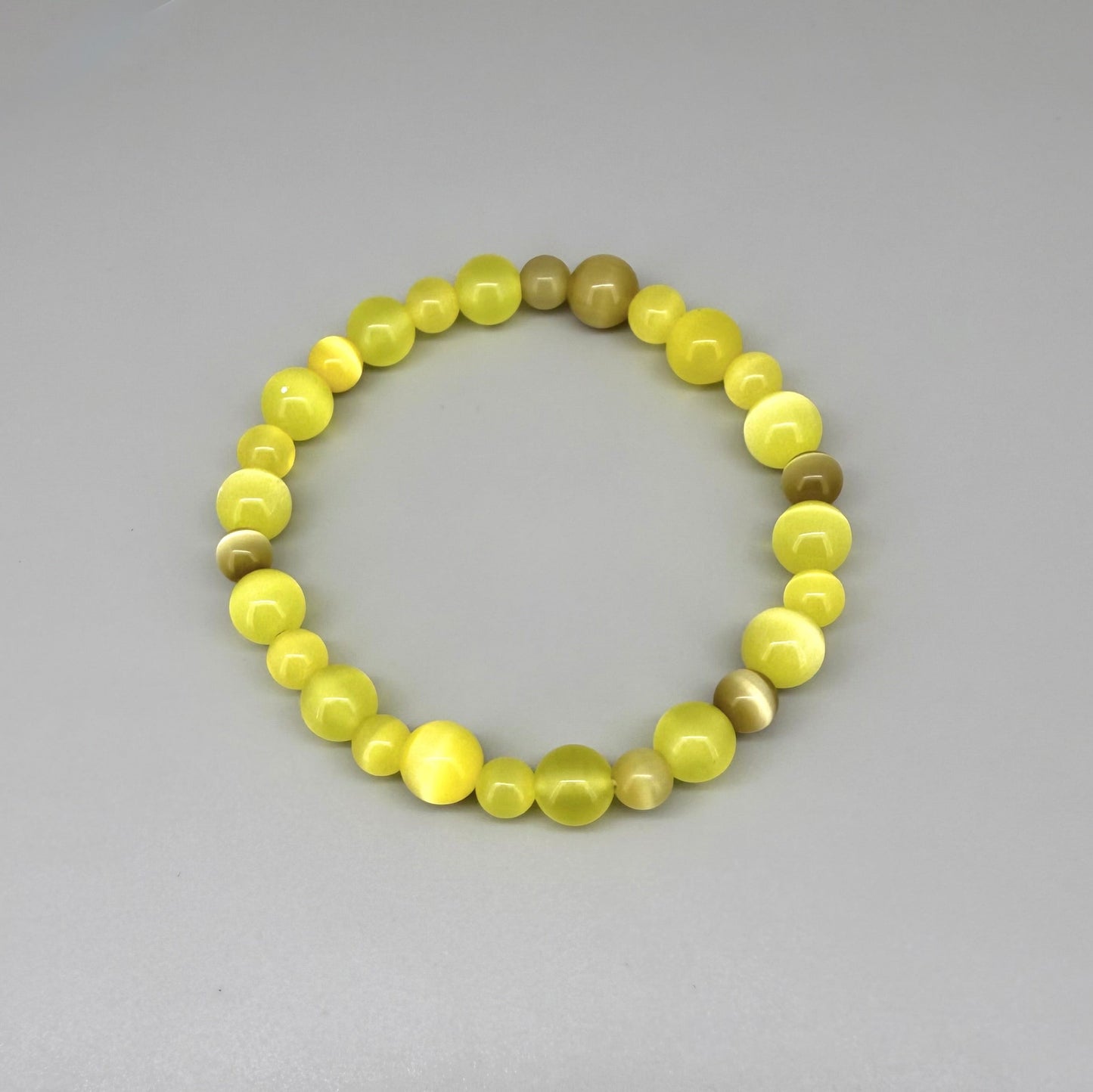 Yellow cat’s eye beaded bracelet, 18cm, shimmering yellow beads with brown accent stones on elastic stretch band.
