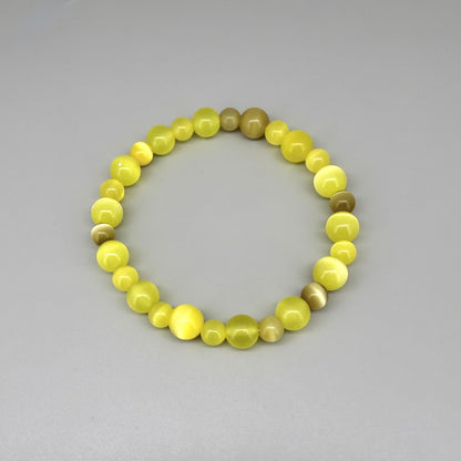 Yellow cat’s eye beaded bracelet, 18cm, shimmering yellow beads with brown accent stones on elastic stretch band.