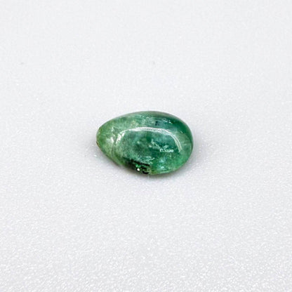 1.42 ct natural untreated emerald from Zambia, one side polished and the other cabochon-shaped.