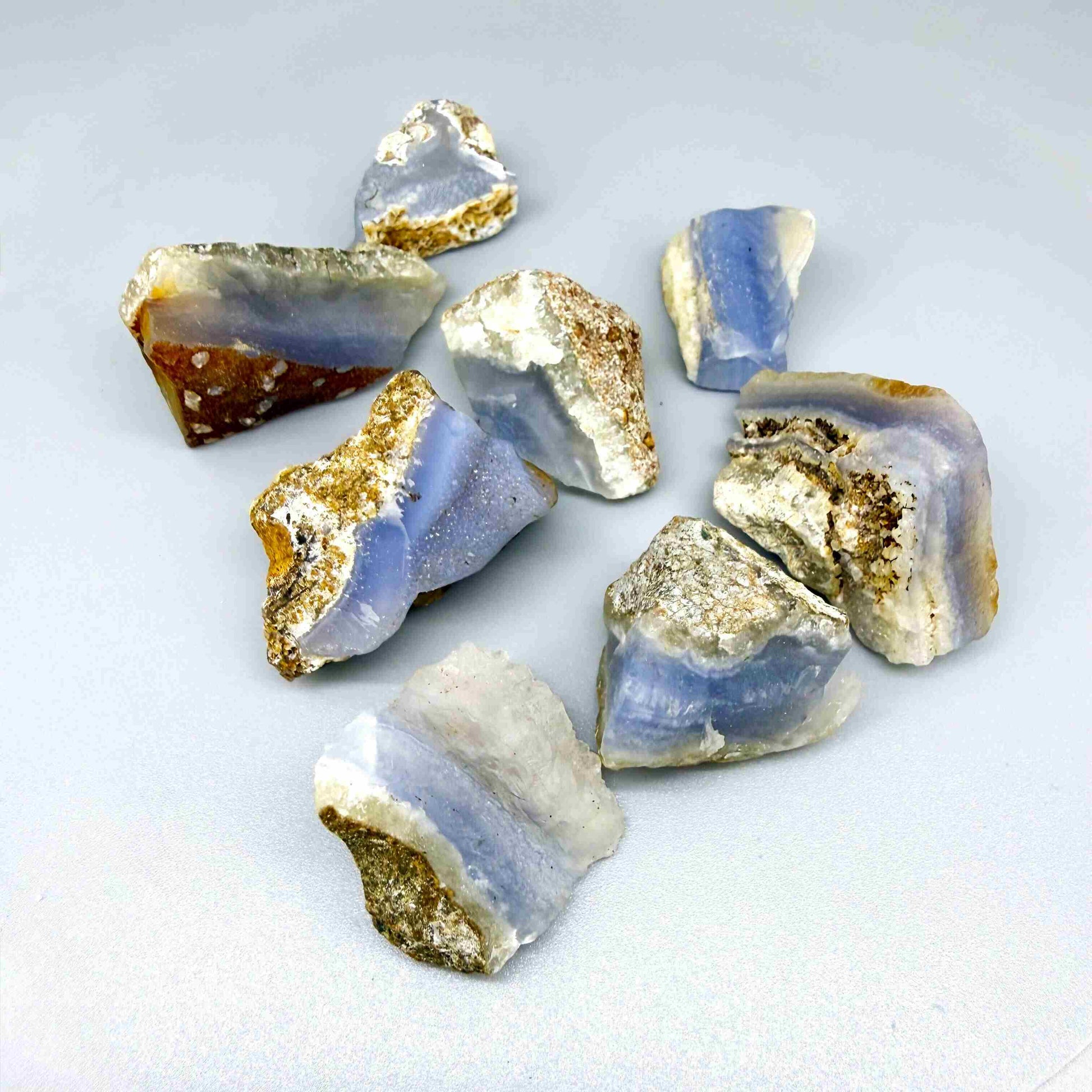 Untreated blue chalcedony rough lot with milky appearance and natural banding