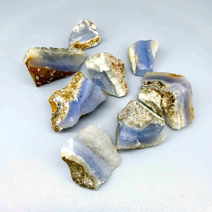 Untreated blue chalcedony rough lot with milky appearance and natural banding