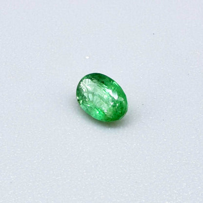 0.22 ct natural untreated Zambian emerald, oval faceted with vivid bluish-green color.