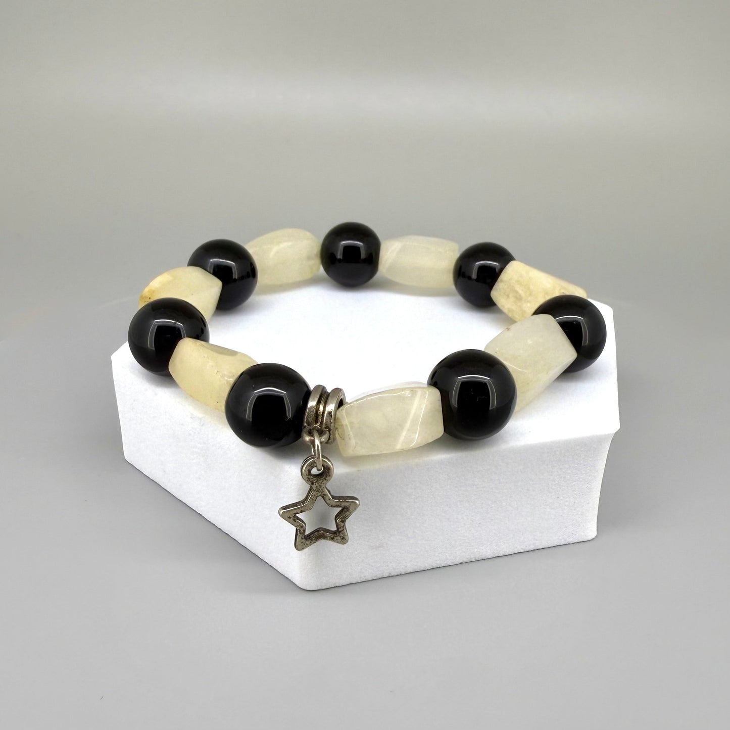 Jade and onyx beaded bracelet, 18cm, beige square jade stones with round black onyx beads and star charm on elastic stretch band.