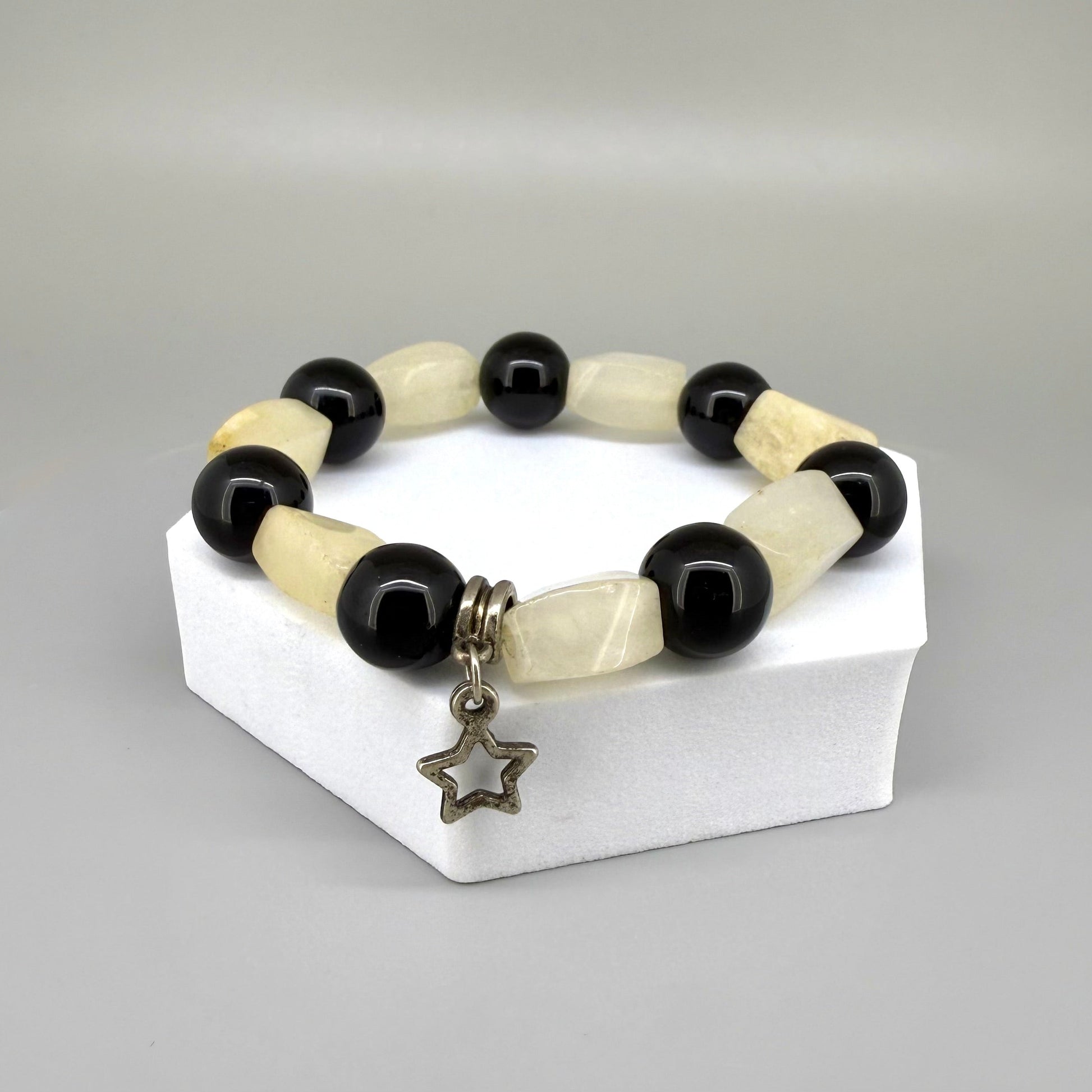 Jade and onyx beaded bracelet, 18cm, beige square jade stones with round black onyx beads and star charm on elastic stretch band.