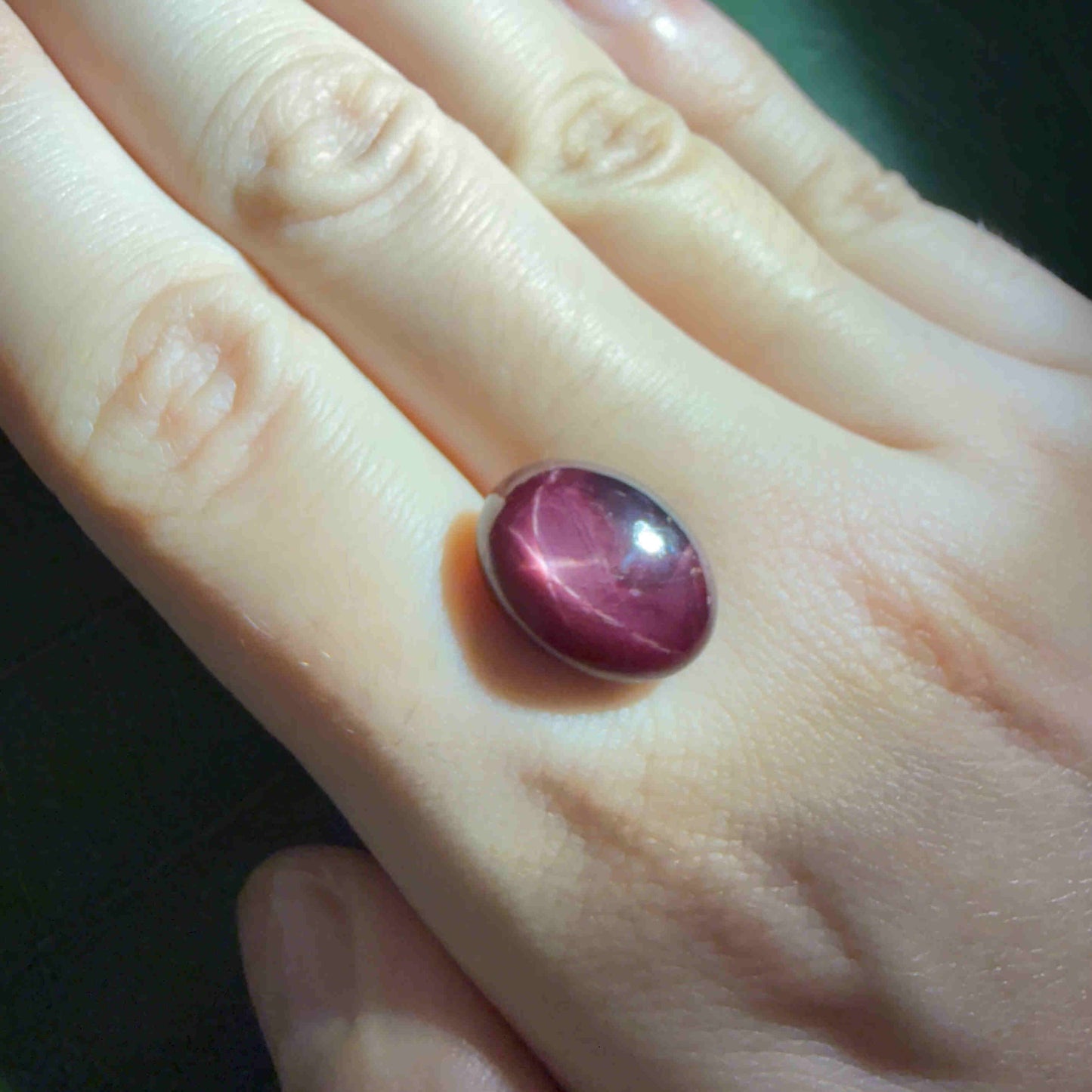 15.5 ct natural Bordeaux-Red Star Ruby cabochon from Mozambique with soft star effect and polished dome.