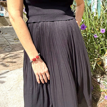 Lava and cinnabar-style beaded bracelet, 18cm, black lava beads with two carved red resin accent beads on elastic stretch band.