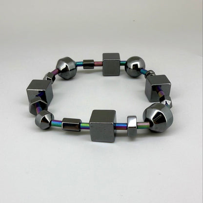 Hematite bracelet, 20cm, geometric cube and sphere beads with rainbow-toned connectors on elastic stretch band.