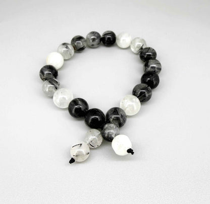 Rutilated quartz mala bracelet made from natural rutilated quartz beads, symbolizing clarity, focus, and inner direction.