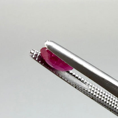 0.6 ct natural Songea ruby, oval cut in a pink-red tone.